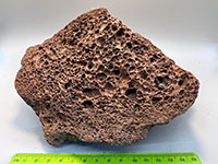 a frothy red lava rock with lots of bubbles